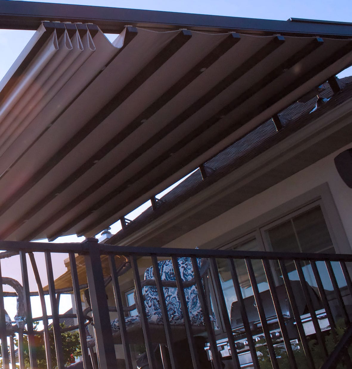 Modern pergola with a Retractable Pergola Cover partially open