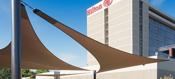 Shade sails outside of a hilton hotel