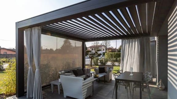 Premium louvered pergola over an outdoor kitchen and seating area